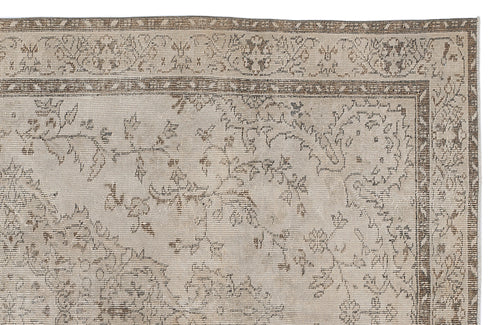 Load image 1 in gallery view. Beige and taupe vintage-style rug with a distressed floral vine pattern and a decorative border.