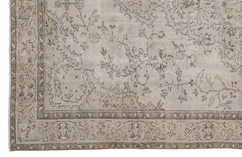 Load image 1 in gallery view. Beige and taupe vintage-style rug with a distressed floral pattern and a detailed geometric border.