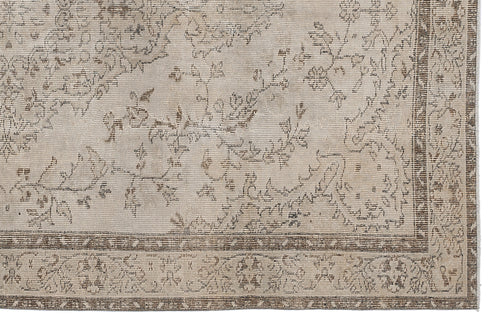 Load image 1 in gallery view. Beige and brown distressed rug with a traditional floral vine pattern and a geometric border.
