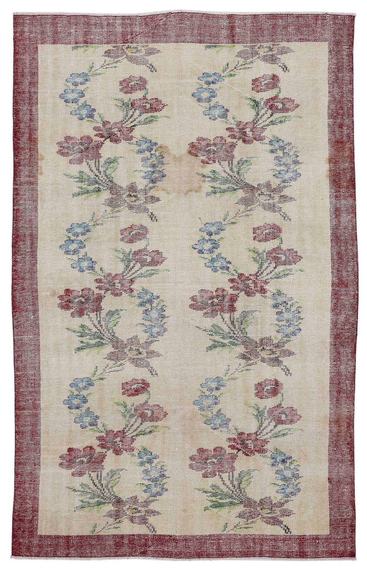 Beige rug with a red border and vertical columns of floral motifs in red, blue, and green.
