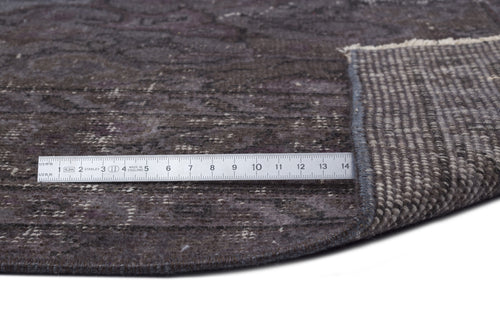 Load image 1 in gallery view. Dark charcoal distressed rug with a faded traditional pattern, shown with a metal ruler for scale on a white background.
