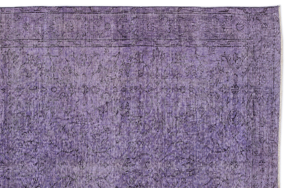 Deep purple vintage-style rug with a distressed, faded floral medallion pattern and a linear border.