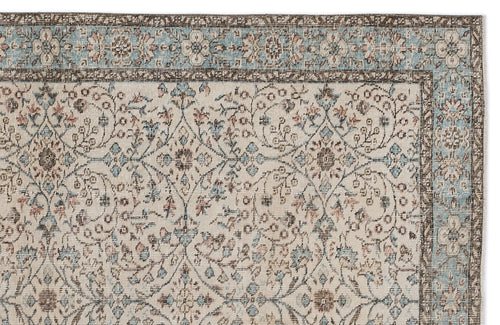 Load image 1 in gallery view. Cream rug with a blue and brown floral medallion pattern and a decorative border on a white background.