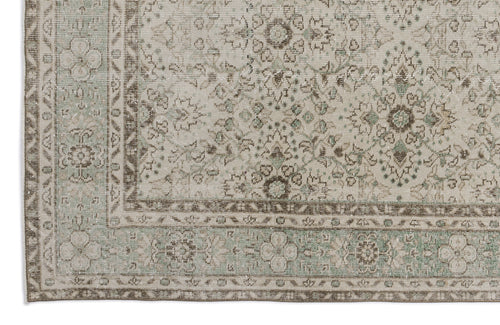 Load image 1 in gallery view. Beige and sage green traditional rug with a distressed floral medallion pattern and a detailed border.