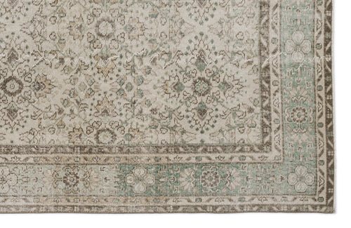 Load image 1 in gallery view. Beige and sage green vintage-style rug with a distressed floral medallion pattern and a detailed geometric border.