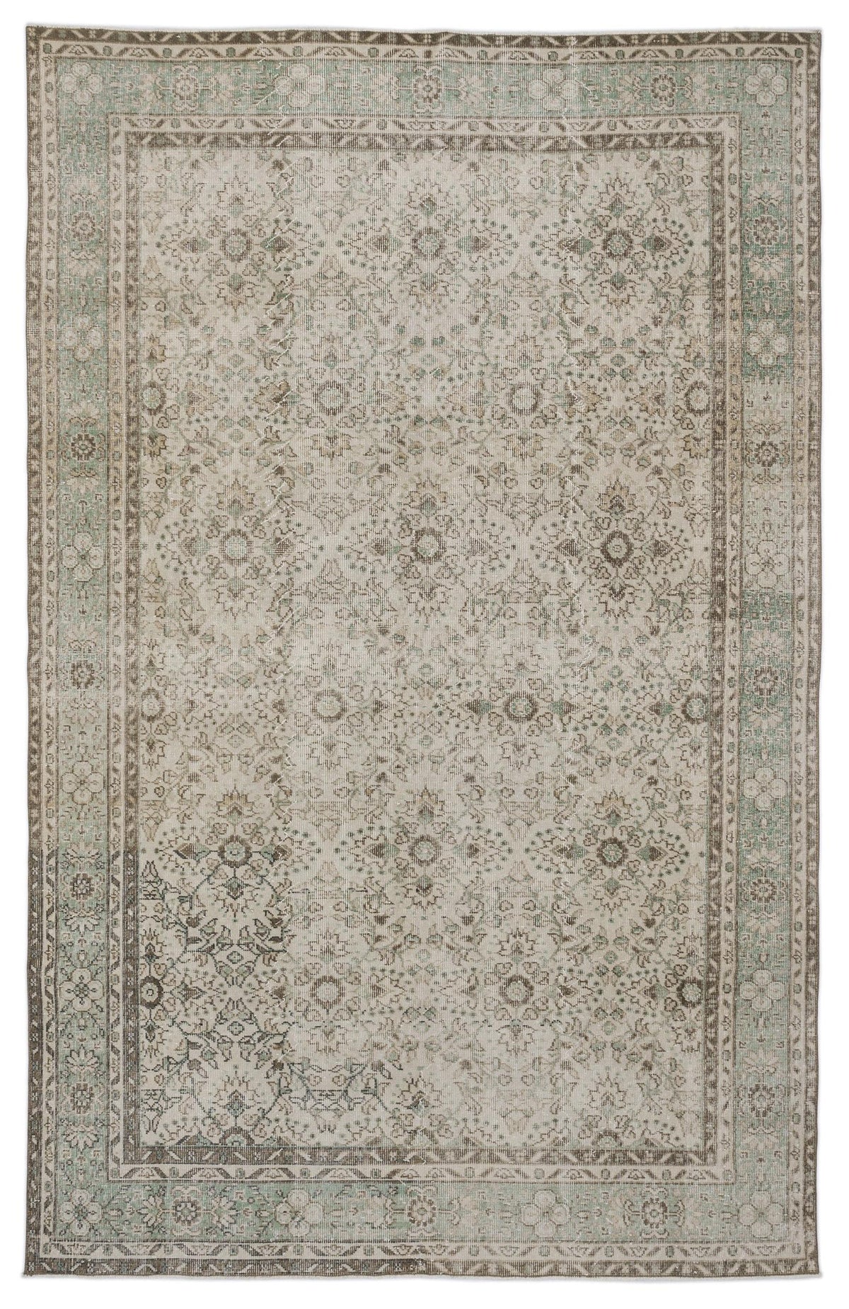Distressed beige and sage green rug with a traditional floral medallion pattern and a decorative border.