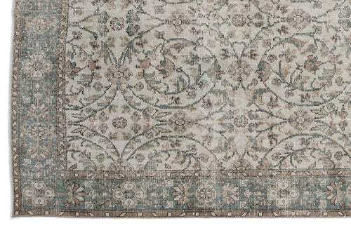 Load image 1 in gallery view. Distressed beige rug with a faded floral medallion pattern in muted sage green and dusty rose, featuring a wide border.