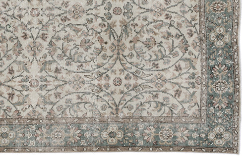 Load image 1 in gallery view. Beige, sage green, and muted pink traditional rug with a distressed floral medallion pattern and a decorative border.