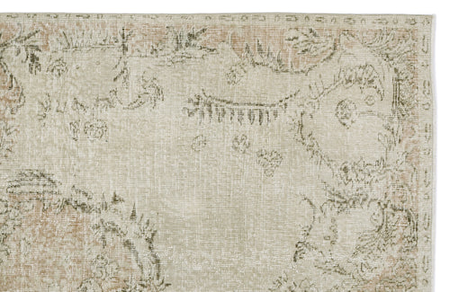 Load image 1 in gallery view. Beige and sage green distressed rug with a faded traditional floral medallion pattern on a white background.