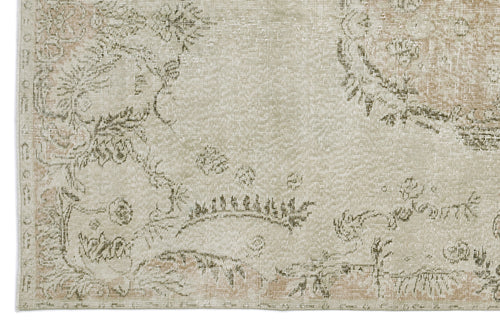Load image 1 in gallery view. Beige and sage green distressed rug with a faded traditional floral medallion pattern.