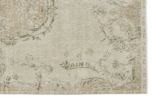 Load image 1 in gallery view. Beige and sage green distressed rug with a faded floral medallion pattern.