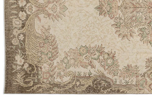 Load image 1 in gallery view. Beige and brown rug with a traditional floral medallion pattern and distressed texture.