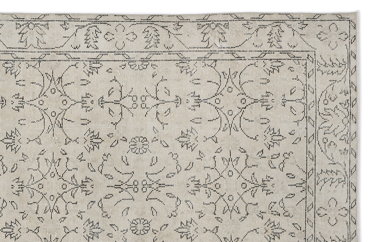 Beige rug with a dark grey linear floral medallion pattern and a thin border on a white background.