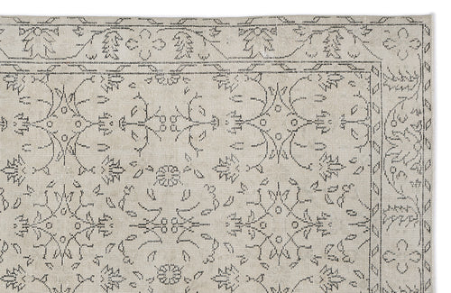 Load image 1 in gallery view. Beige rug with a dark grey linear floral medallion pattern and a thin border on a white background.