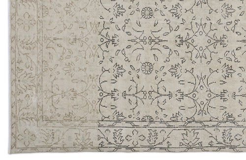 Load image 1 in gallery view. Beige and grey rug with a faded traditional floral medallion pattern and a decorative border.