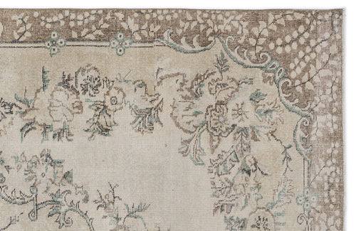 Load image 1 in gallery view. Beige and brown traditional rug with a distressed floral medallion pattern and teal accents.