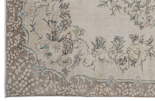 Load image 1 in gallery view. Beige and brown traditional rug with a distressed floral medallion pattern and muted teal accents.