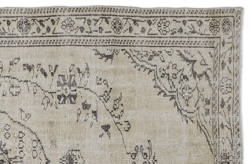 Load image 1 in gallery view. Beige and charcoal distressed rug with a traditional floral medallion border and faded botanical motifs.