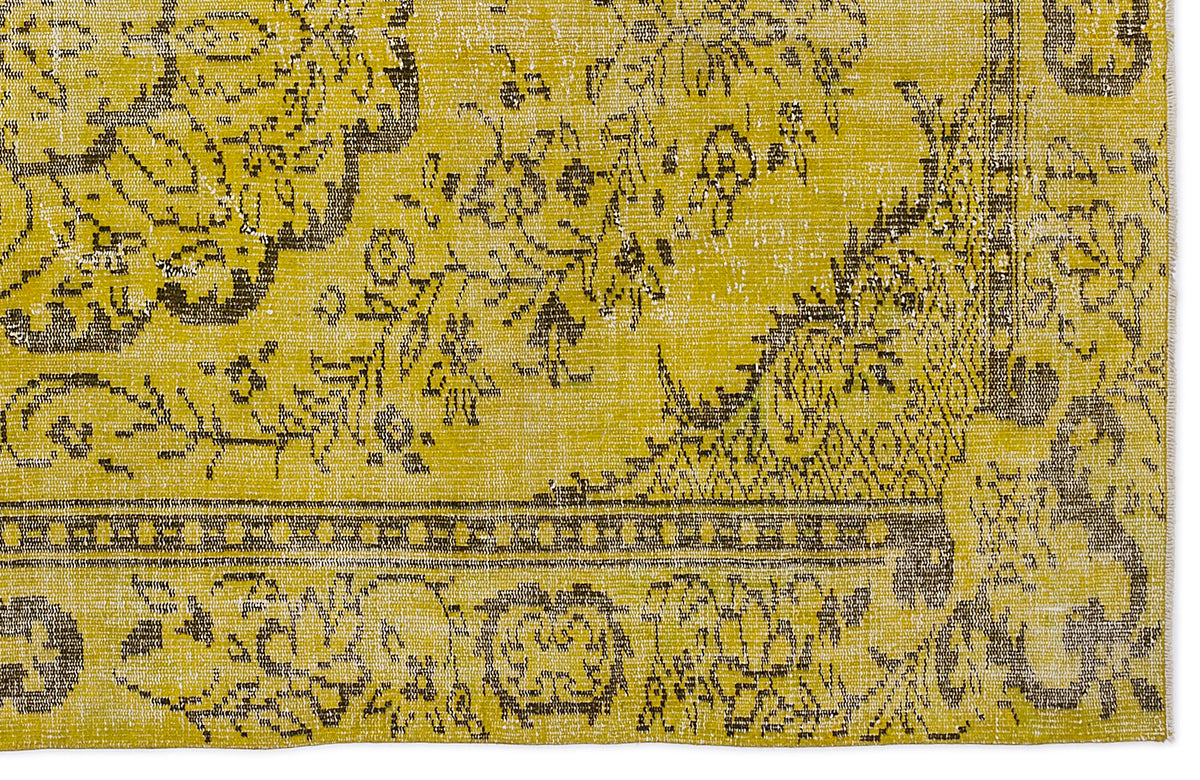 Mustard yellow and charcoal grey rug with a distressed traditional floral medallion pattern and a geometric border.