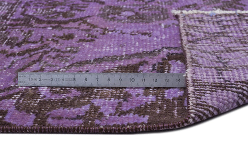 Load image 1 in gallery view. Purple and brown distressed medallion rug with a metal ruler showing scale on a white background.