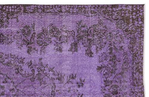Load image 1 in gallery view. Distressed purple and black vintage-style rug with a floral medallion pattern.