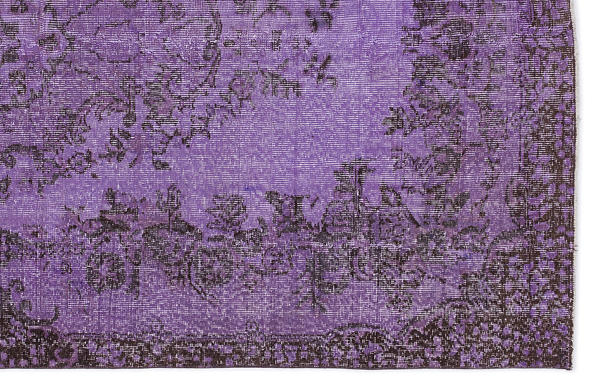 Deep purple and black distressed rug with a traditional floral medallion pattern.