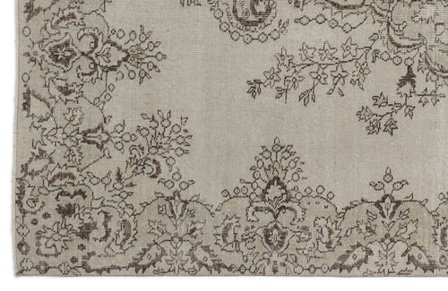 Load image 1 in gallery view. Beige rug with a dark brown distressed floral and paisley pattern.