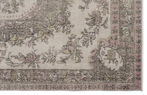 Load image 1 in gallery view. Distressed beige rug with a faded floral pattern in muted pink and olive green, featuring a decorative border.