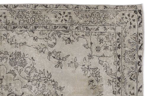 Load image 1 in gallery view. Distressed beige and charcoal grey rug with a traditional floral border and central vine motif.