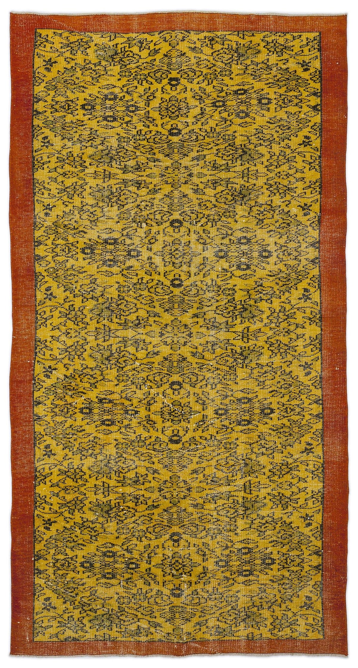 Mustard yellow rug with a black floral medallion pattern and a solid burnt orange border.