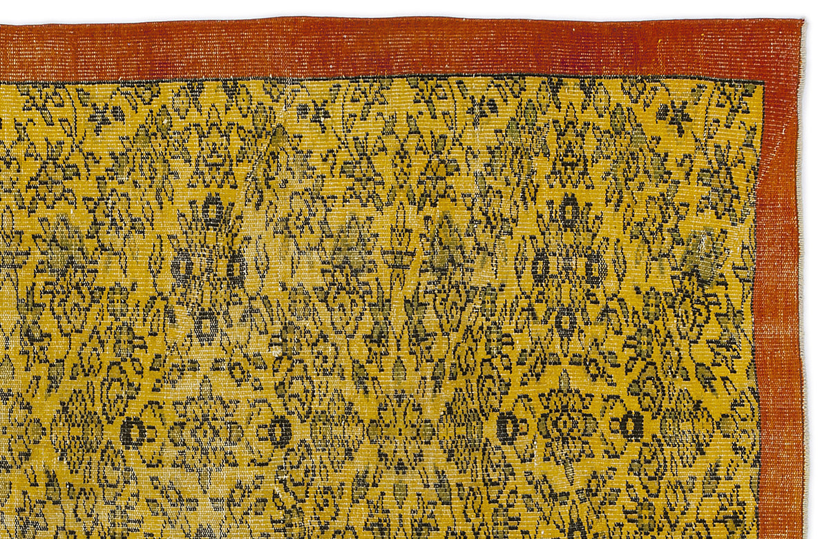 Mustard yellow rug with a black floral medallion pattern and a wide terracotta border on a white background.