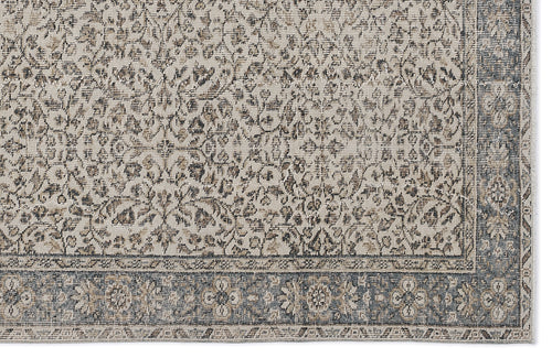 Load image 1 in gallery view. Beige and charcoal grey rug with a distressed traditional floral pattern and a wide decorative border.