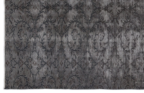 Load image 1 in gallery view. Charcoal and grey distressed rug with a repeating floral medallion pattern.