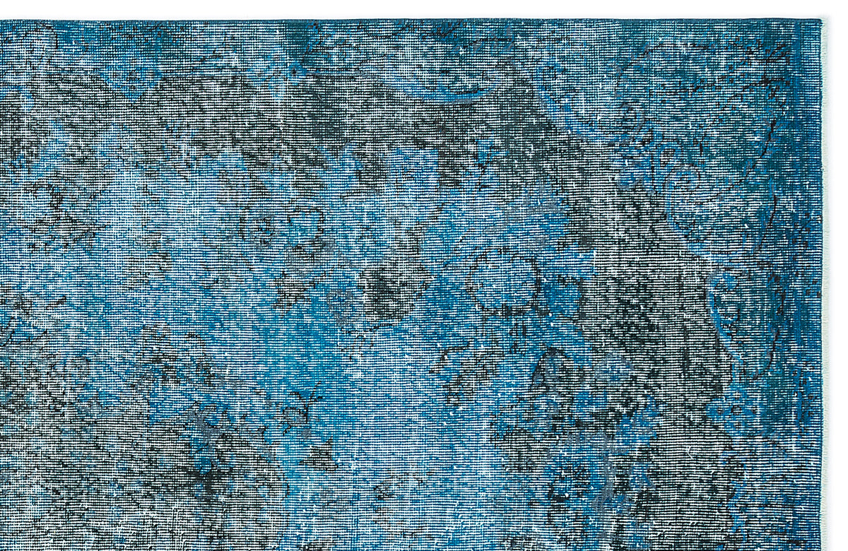 Deep blue and black distressed rug with a faded, traditional medallion pattern on a white background.
