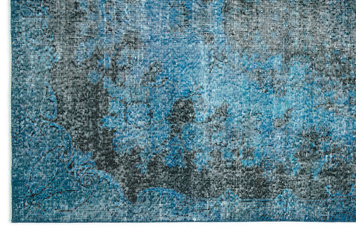 Load image 1 in gallery view. Blue and black distressed rug with a faded, abstract vintage-inspired pattern.