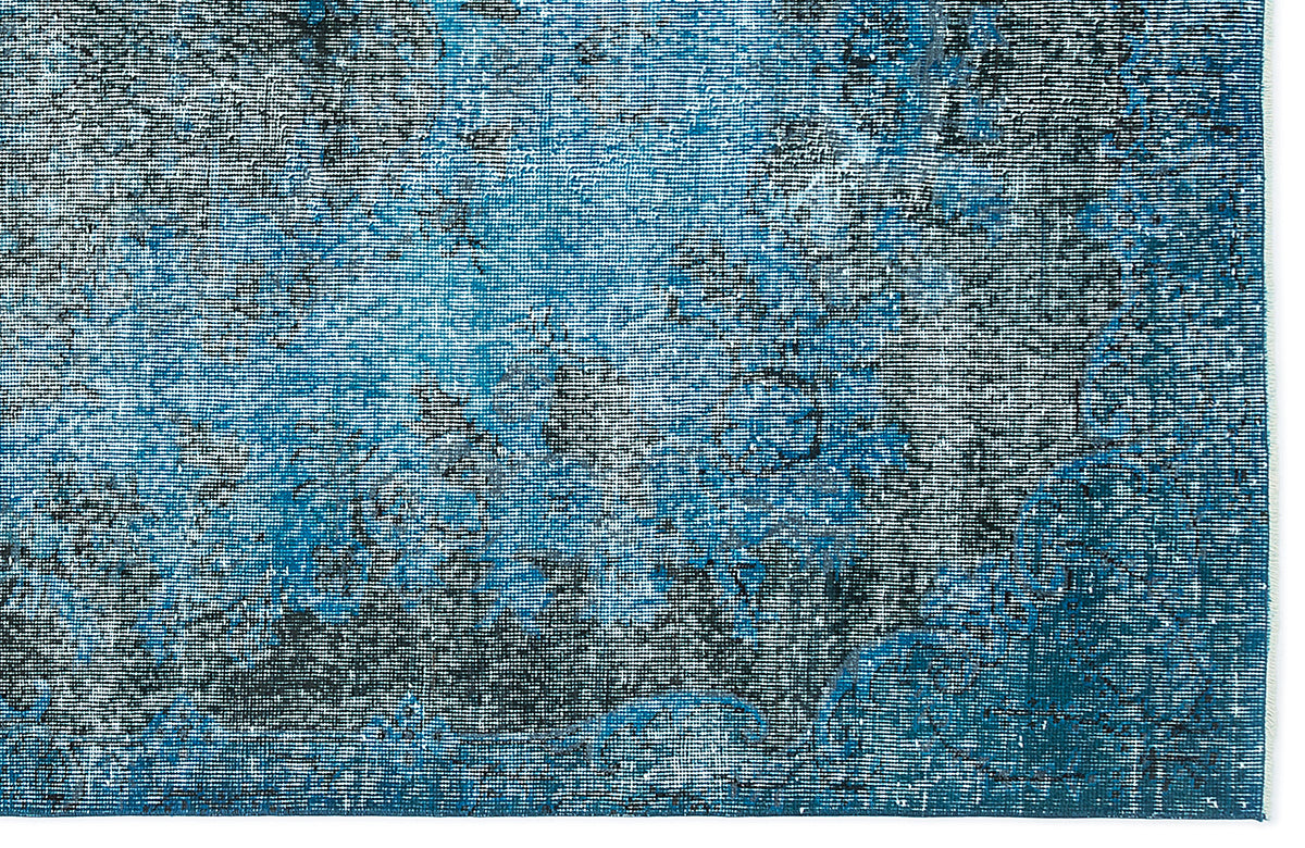 Blue and black distressed rug with a faded, abstract traditional pattern on a white background.