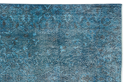 Load image 1 in gallery view. Deep blue distressed rug with a faded traditional floral medallion pattern on a white background.