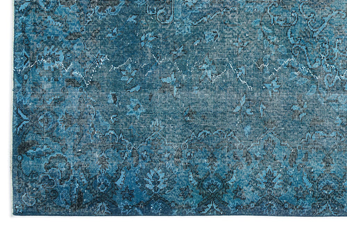 Load image 1 in gallery view. Deep blue distressed rug with a faded traditional floral medallion pattern.