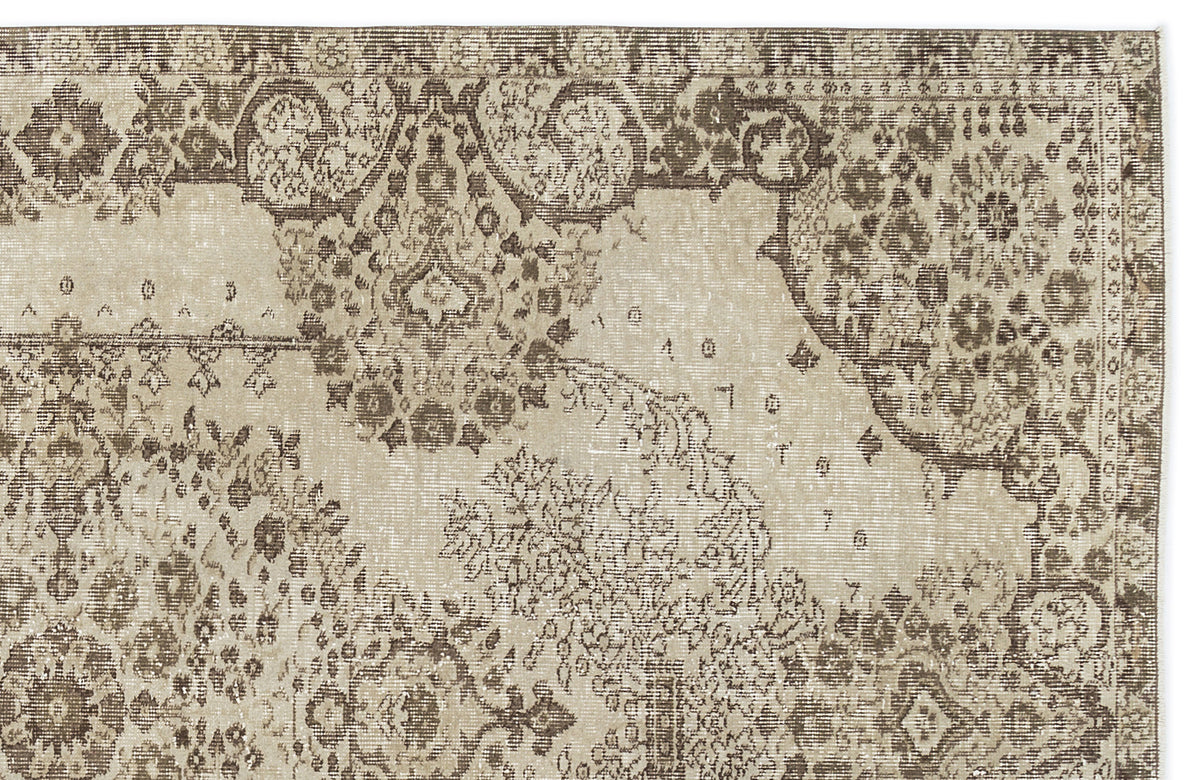 Beige and brown distressed rug with a traditional ornate floral medallion pattern.