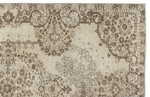 Load image 1 in gallery view. Beige and brown distressed rug with a traditional ornate floral medallion pattern.