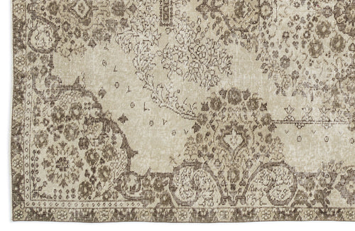 Load image 1 in gallery view. Beige and brown distressed rug with a faded traditional floral medallion pattern.