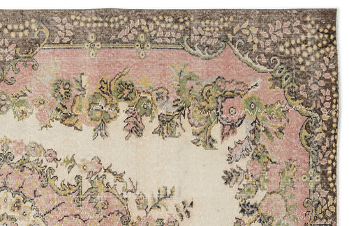 Load image 1 in gallery view. Vintage-style rug fragment with a floral medallion pattern in muted pink, sage green, and brown on a cream background.