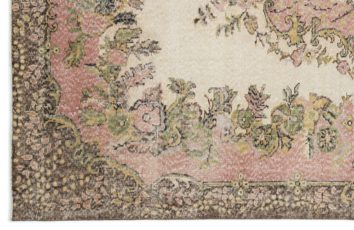 Load image 1 in gallery view. Distressed floral medallion rug in cream, dusty pink, olive green, and dark brown with a traditional border.