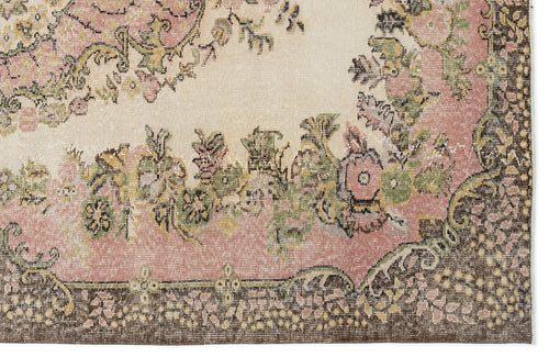 Load image 1 in gallery view. Distressed cream rug with a pink and green floral medallion pattern and a dark brown border.