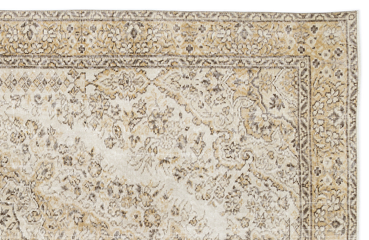 Beige and cream vintage-style rug with a distressed traditional floral medallion pattern and a detailed border.