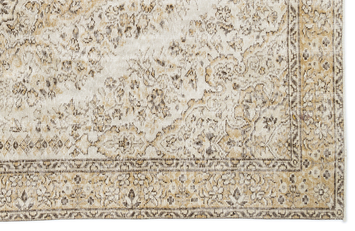 Beige and cream traditional rug with a distressed floral medallion pattern and a detailed border.