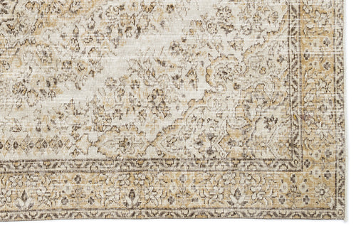 Load image 1 in gallery view. Beige and cream traditional rug with a distressed floral medallion pattern and a detailed border.