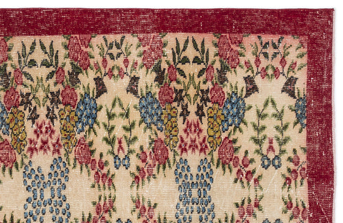 Load image 1 in gallery view. Beige rug with a red border and a repeating floral pattern in red, blue, yellow, and green on a white background.