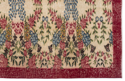 Load image 1 in gallery view. Beige rug with a floral pattern in red, blue, and green, featuring a wide red border.