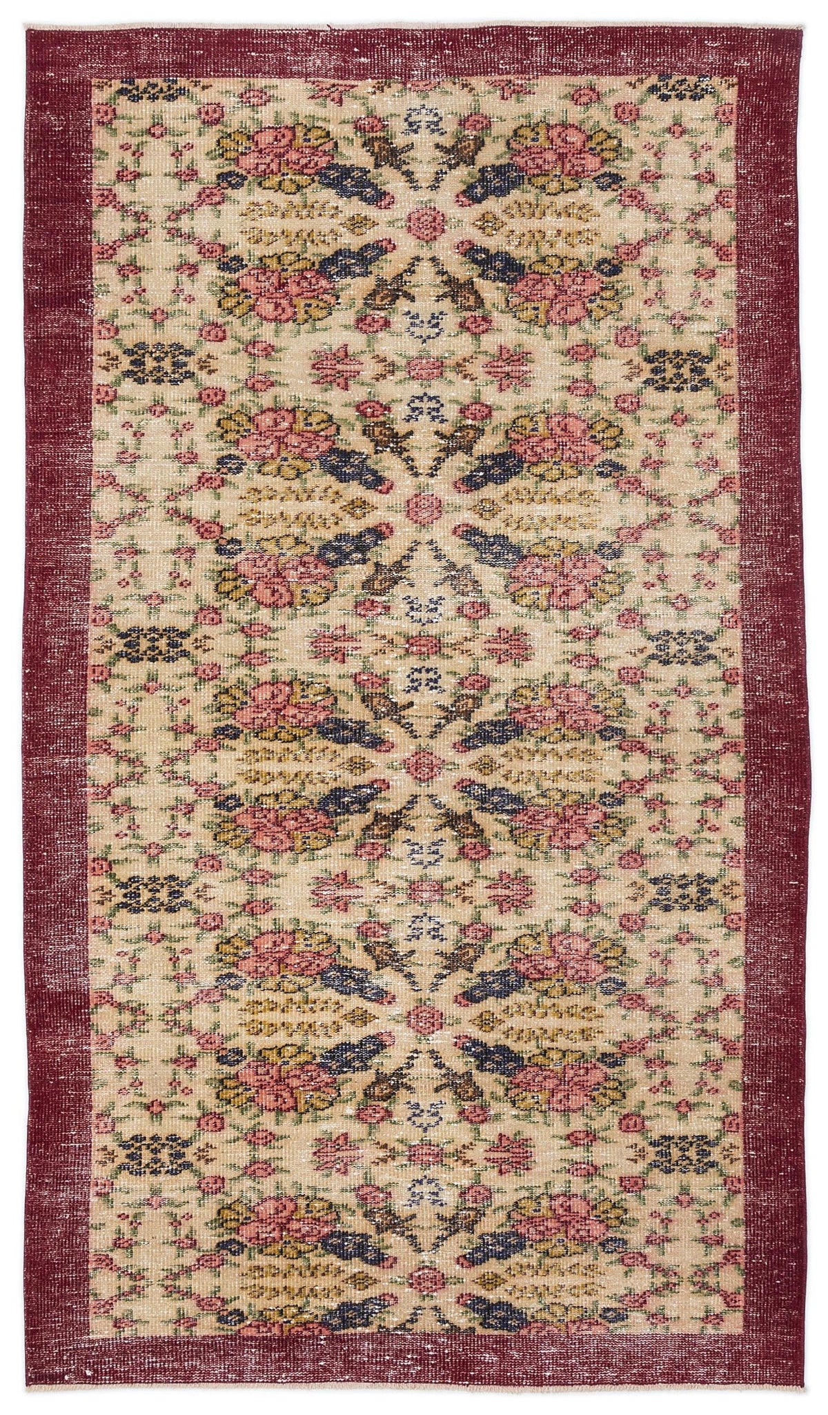 Beige vintage-style rug with a deep red border and a repeating floral medallion pattern in pink, blue, and yellow.